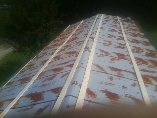 Rusted metal roof panels with new wood purlins before replacement — Storm Damage Roof Repair in Wrens by Roofing Brothers