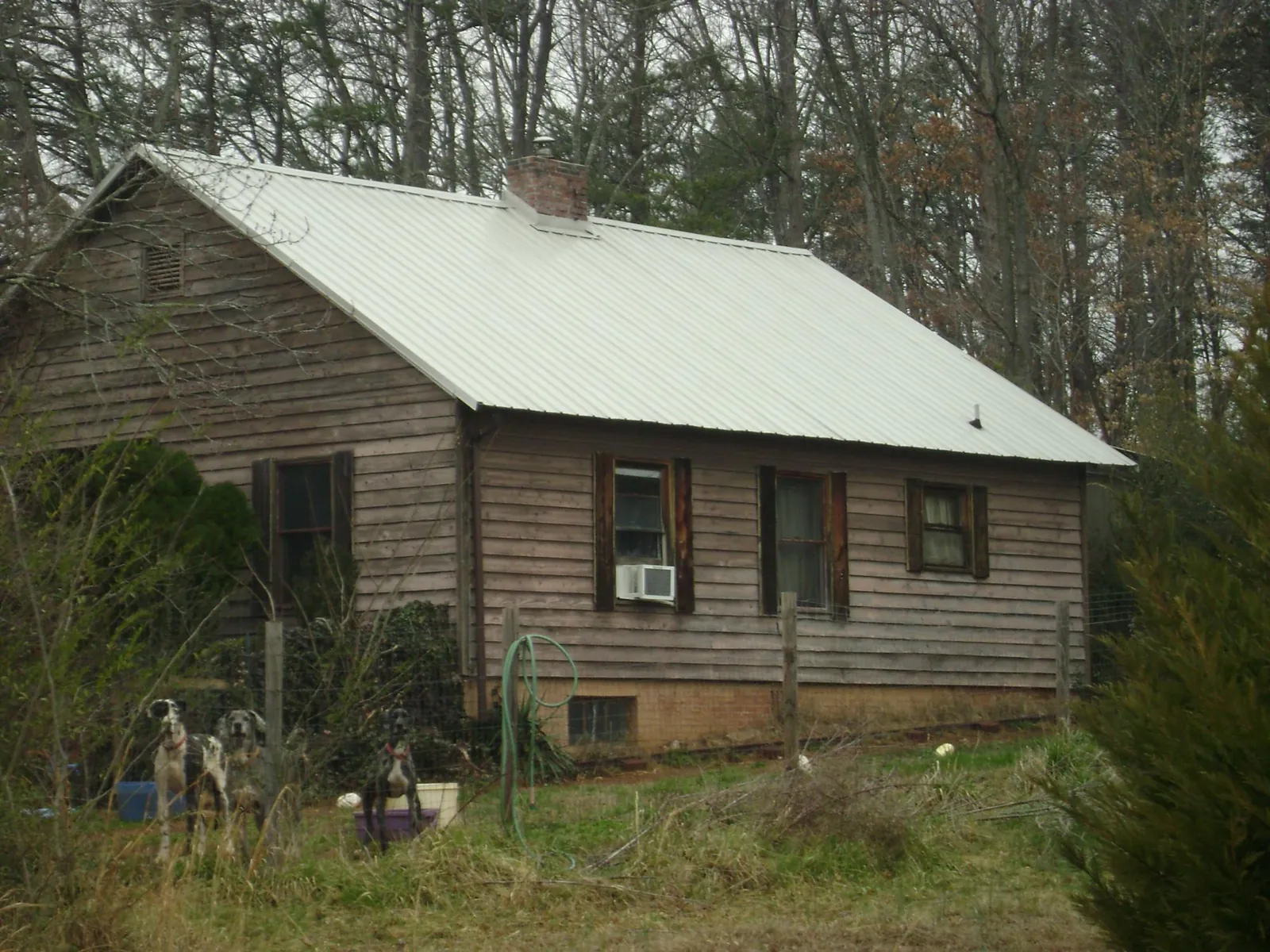 White metal roof on an old wood sided farmhouse, from a Metal Roof Installation job in Wrens